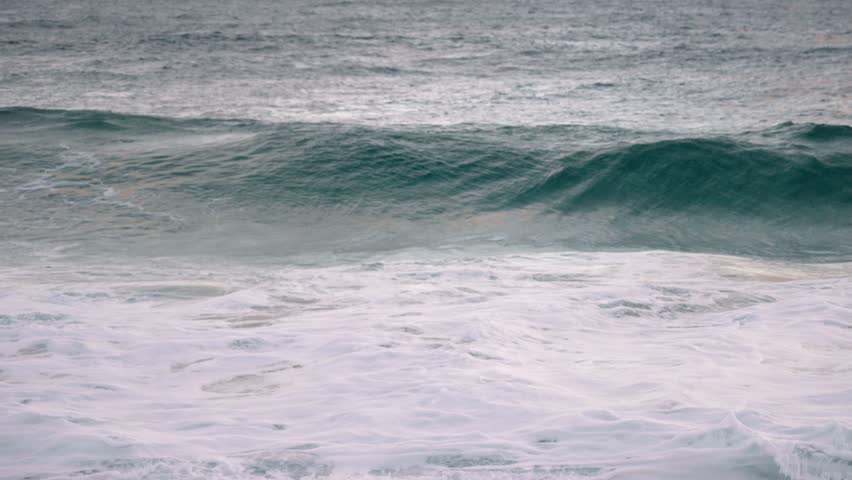 wave crashing in slow motion at north shore sunset Honolulu Hawaii