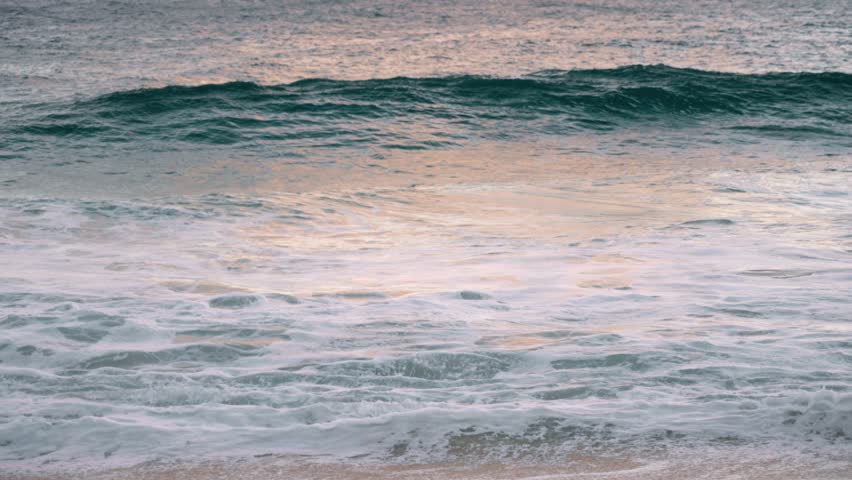 wave crashing in slow motion at north shore sunset Honolulu Hawaii