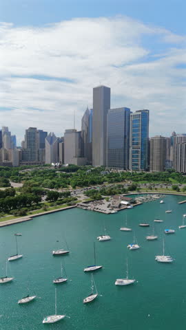Experience the breathtaking beauty of the vibrant city of Chicago from above, showcasing its stunning skyline and lush green parks, which line the scenic waterfront beautifully, inviting exploration
