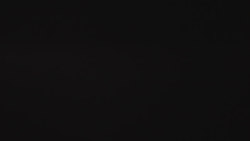 Powerful forked lightning bolts flash across the dark evening sky, splitting the night with intense electric energy and illuminating storm clouds in a dramatic weather display