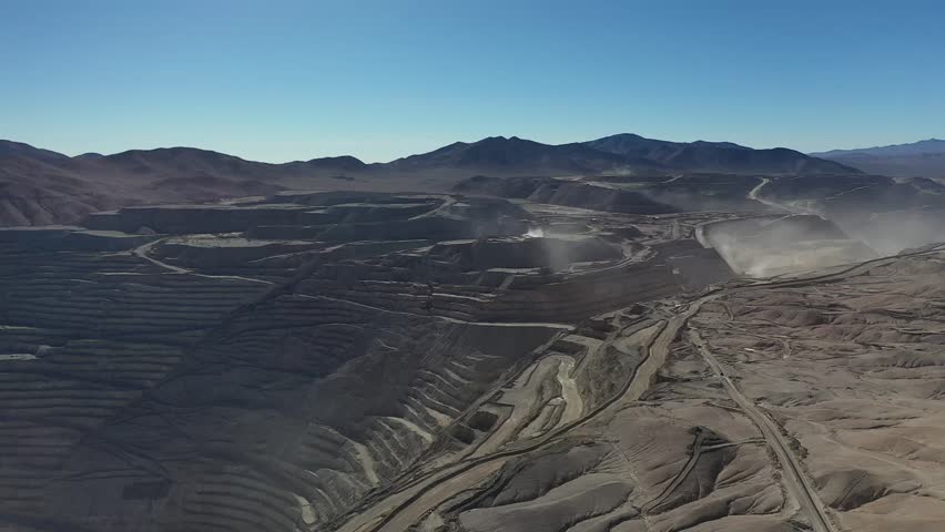 Stunning aerial drone footage of Chuquicamata, one of the world’s largest open-pit copper mines, located in the heart of Chile’s Atacama Desert. This panoramic view showcases the vast scale of mining 
