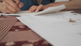 Close-up video of a woman’s hand writing elegant calligraphy on cream parchment, creating handmade wedding-invitation stationery; the smooth pen strokes and soft lighting highlight the craft, romance, - Powered by Shutterstock - Get 15% off with code: PIKWIZARD15