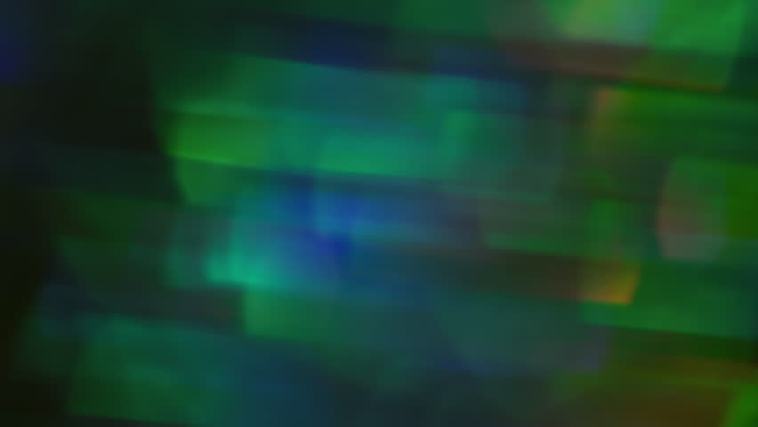 Kaleidoscope twirl. Light blur. Sparkling yellow green red blue colors lens flare changing on blurred abstract modern bokeh background.