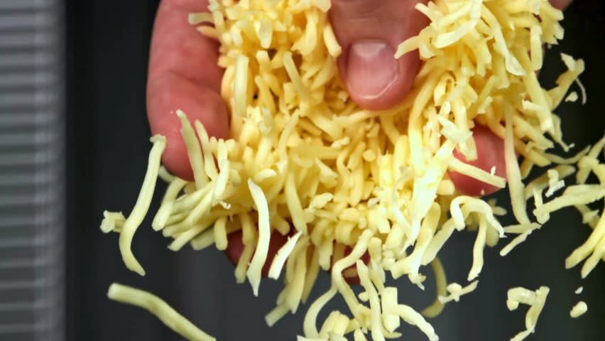 A chef demonstrates how to shred cheese by hand, using a variety of techniques to achieve the ideal texture and consistency for different dishes. This technique enhances any meal.