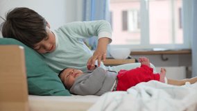 Older sibling embraces baby on a bed, creating a serene and loving scene in a cozy, sunlit room filled with warmth and affection - Powered by Shutterstock - Get 15% off with code: PIKWIZARD15