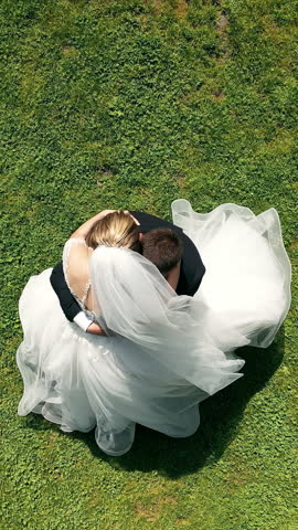 Aerial Top view of the wedding dance of the newlyweds. The groom spins the bride while holding him in his arms.