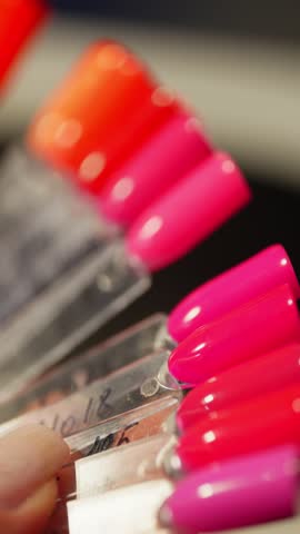 The client chooses the color of the nails on the samples. Manicure at the master in the beauty salon. High quality 4k footage