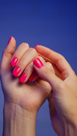 Beautifully painted nails close-up of a woman's manicure. Pink nails made by a manicurist in a salon. High quality 4k footage