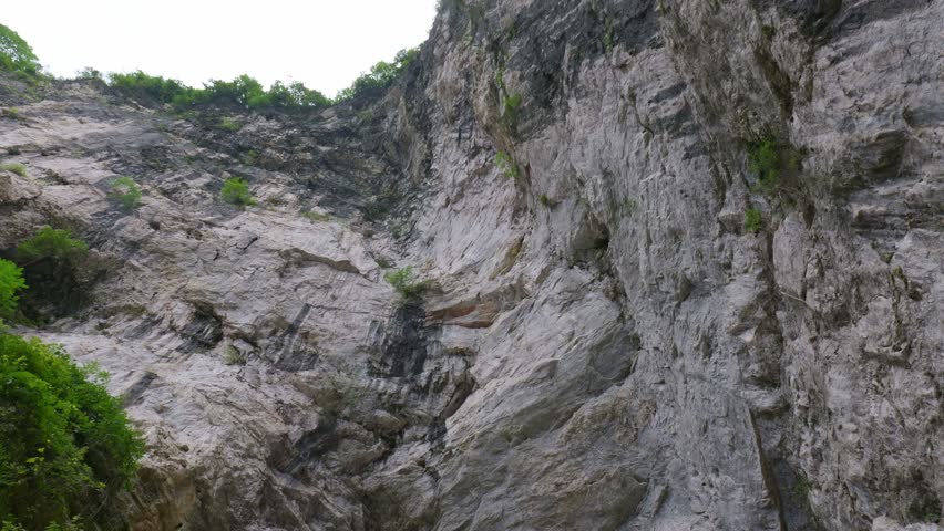 A dangerous wooden house built on top of a giant rock.