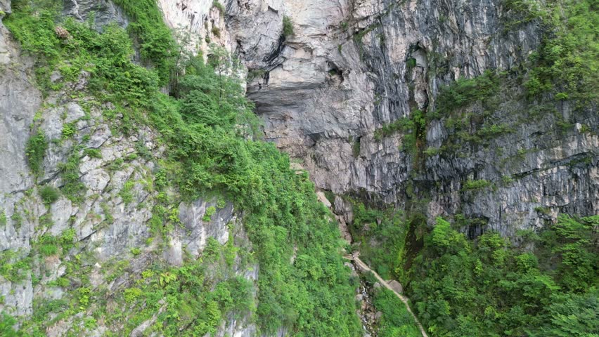 A dangerous wooden house built on top of a giant rock.