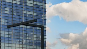 Glass facade with modern street lantern reflecting moving clouds and shifting sunlight shadows - Powered by Shutterstock - Get 15% off with code: PIKWIZARD15