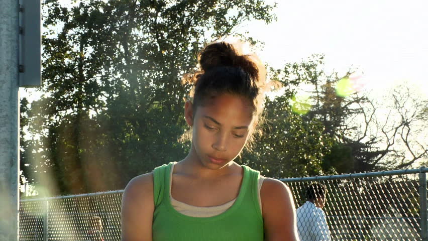 The camera zooms into a young, teary-eyed girl.