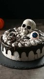 Spooky Halloween chocolate Cake with Skull, Eyeball, and Spider Decoration on dark background	
 - Powered by Shutterstock - Get 15% off with code: PIKWIZARD15