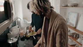 A gay couple is making breakfast together in their modern kitchen. They are slicing avocado and oranges, and preparing toast. This clip depicts a loving, domestic scene of a gay couple at home. - Powered by Shutterstock - Get 15% off with code: PIKWIZARD15