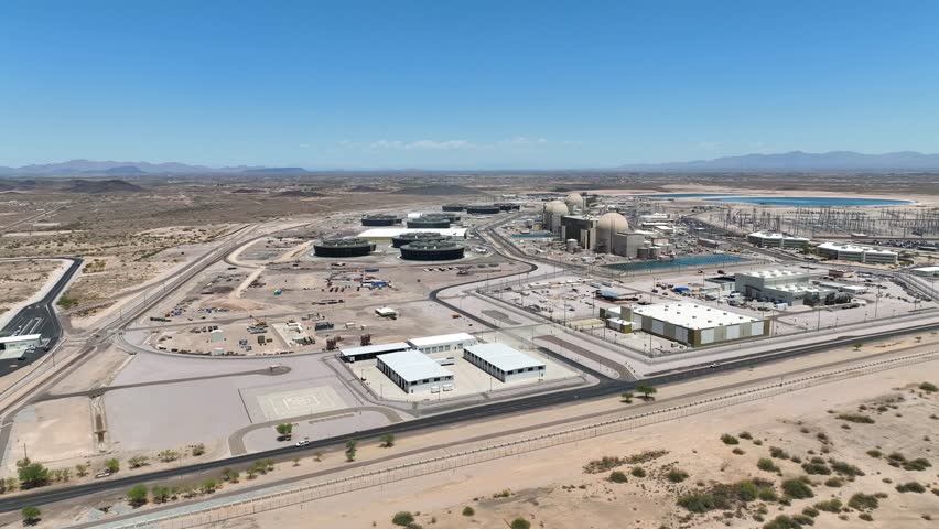 Aerial view of the expansive Palo Verde Generating Station complex set against a desert landscape with fuel tanks and reactor domes, Tonopah, Arizona, United States.