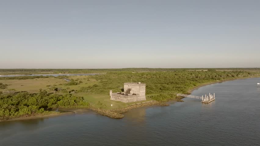 Aerial view of Castillo de San Marcos near the shore, with a contrasting blend of blues from the water and greens from the foliage, St. Augustine, Florida, United States.