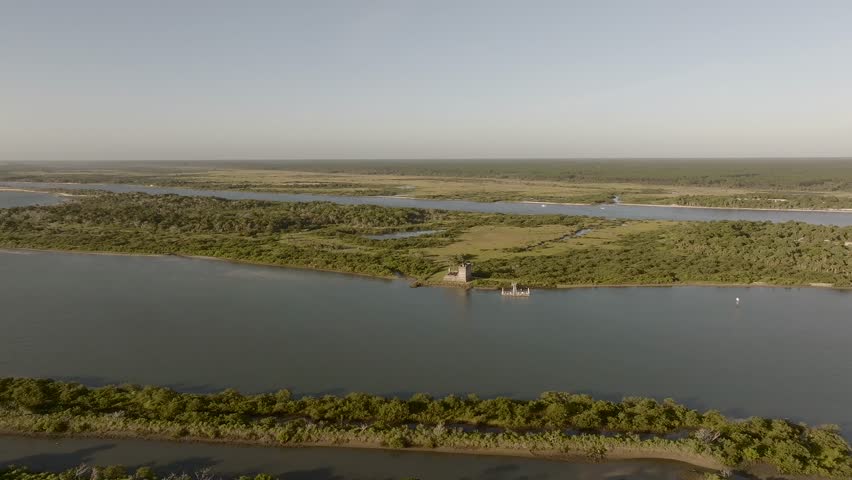 Aerial view of Fort Matanzas surrounded by water and lush green vegetation, creating a vivid contrast of colors, St. Augustine, Florida, United States.