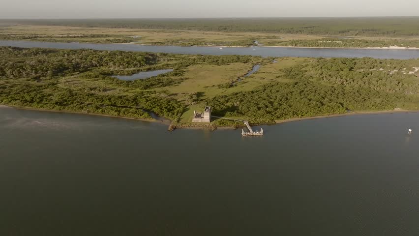 Aerial view of the historic Fort Matanzas surrounded by water and lush greenery creating a tranquil scene, St. Augustine, Florida, United States.