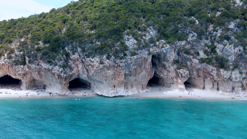Lateral Aerial Drone View of the Caves at Cala Luna Beach – Sardinia, Italy