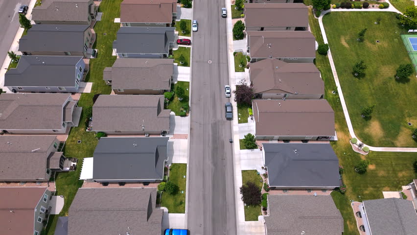 Stunning aerial perspective beautifully showcases a peaceful USA suburban neighborhood that features a variety of modern homes, wellkept green lawns, and a serene atmosphere throughout the area