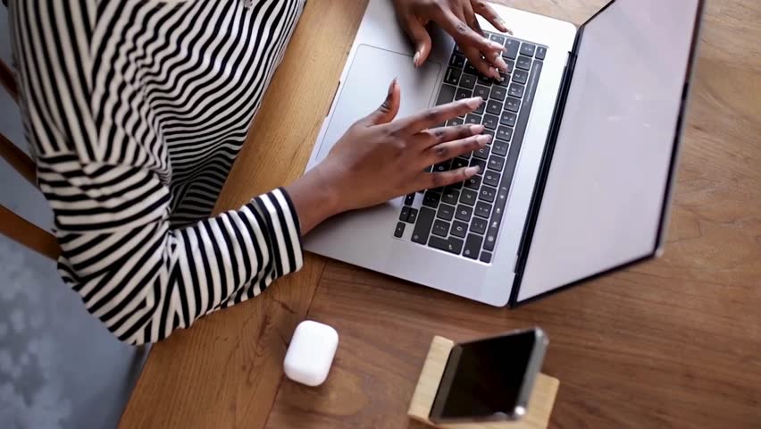 Overhead View of Work From Home Office Space with Person Typing on Laptop – Remote Work Lifestyle Concept in Natural Light - Powered by Shutterstock - Get 15% off with code: PIKWIZARD15