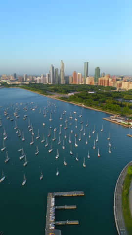 Stunning aerial views showcasing Chicago iconic marina with yacht and skyline, where colorful sailboats gracefully populate the harbor, all within a vibrant and lively atmosphere captivates visitors