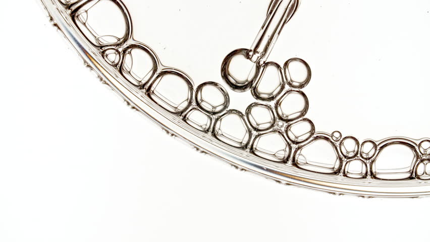 Bubble Cluster, Cells Under a Microscope From a Glass Pipette. Essential Oil, Cosmetic Serum Fluid Gel With Molecule Bubbles. Dermatology science laboratory. Macro Shot of Organic Products.