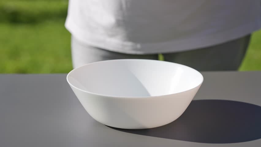 chef put in bowl sliced fresh green romaine lettuce leaves to prepare a healthy salad. outdoor cooking, food closeup