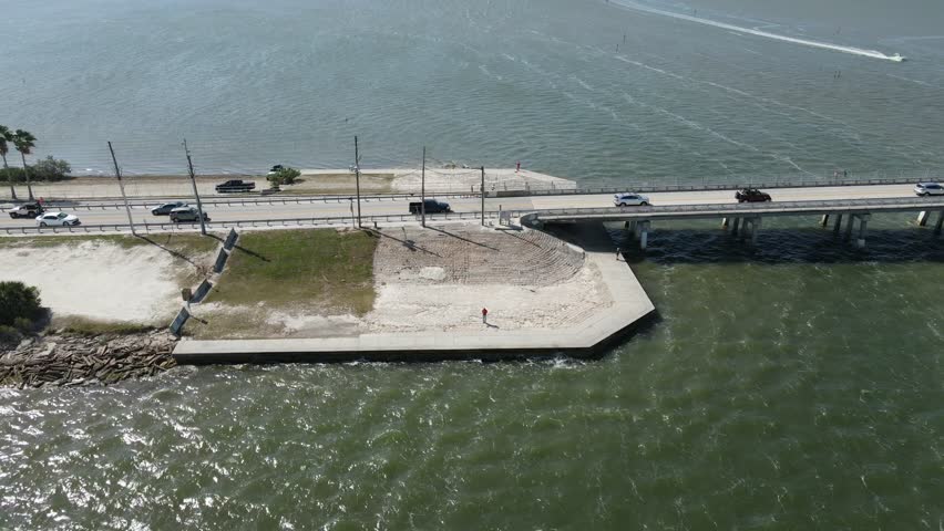 Drone flies backwards from eastern side of Dunedin Causeway in Dunedin, Florida, USA