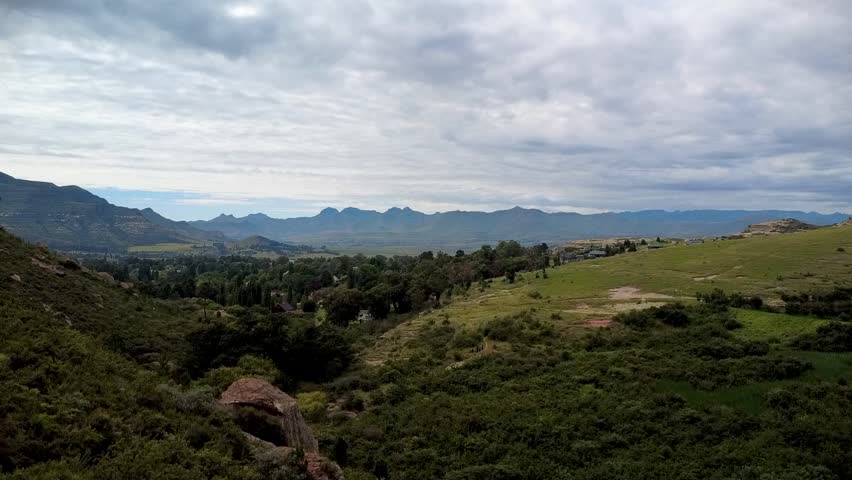 Rising drone shot capturing the scenic beauty of Clarens, Free State, with rolling hills and greenery. Perfect for nature, travel, and adventure projects.