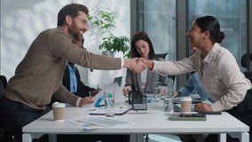 Caucasian business woman team leader showing graph chart talking briefing two multiethnic businesspeople shake hands handshaking gesture men women diverse coworkers in office agreement deal cooperate - Powered by Shutterstock - Get 15% off with code: PIKWIZARD15
