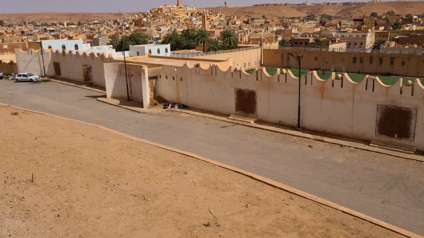 Overlooking Ghardaia in Algeria, where traditional mud-brick homes and rolling desert hills capture the unique character of this Saharan oasis town