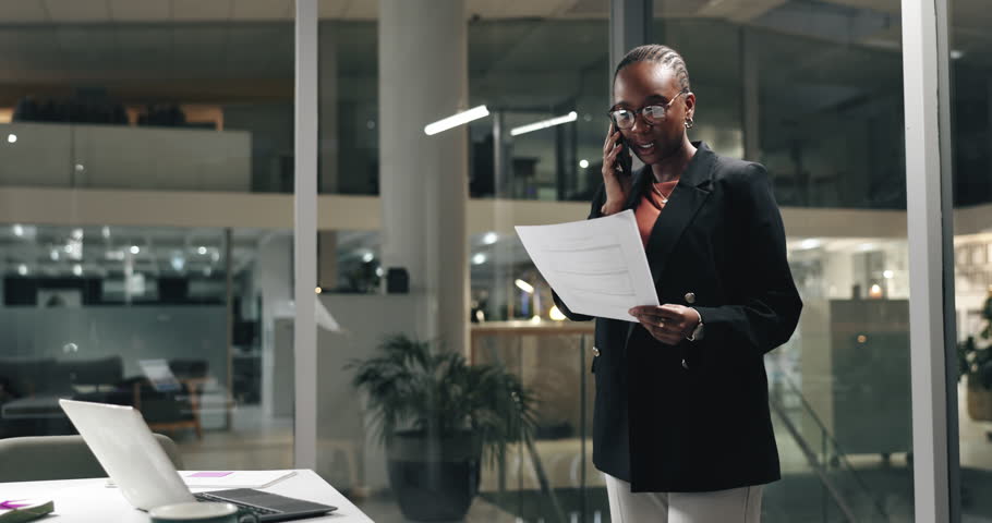 Business, phone call and black woman with documents, night and laptop with financial agency. African person, evening or employee with paperwork cellphone or schedule for trading, app or budget review