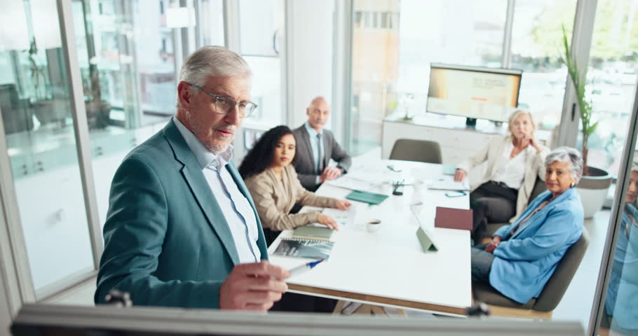 Business man, whiteboard and presentation with team, writing proposal or compliance training. Mature presenter, manager and coaching with group for strategy, policy development and talking in office