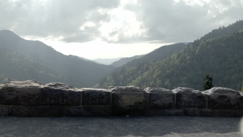 Middle aged woman walking to overlook in the Great Smoky Mountains National Park in slow motion.