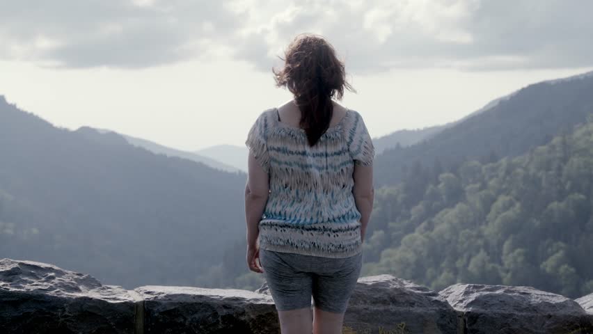 Middle aged woman looking at mountain view in the Great Smoky Mountains National Park in slow motion.