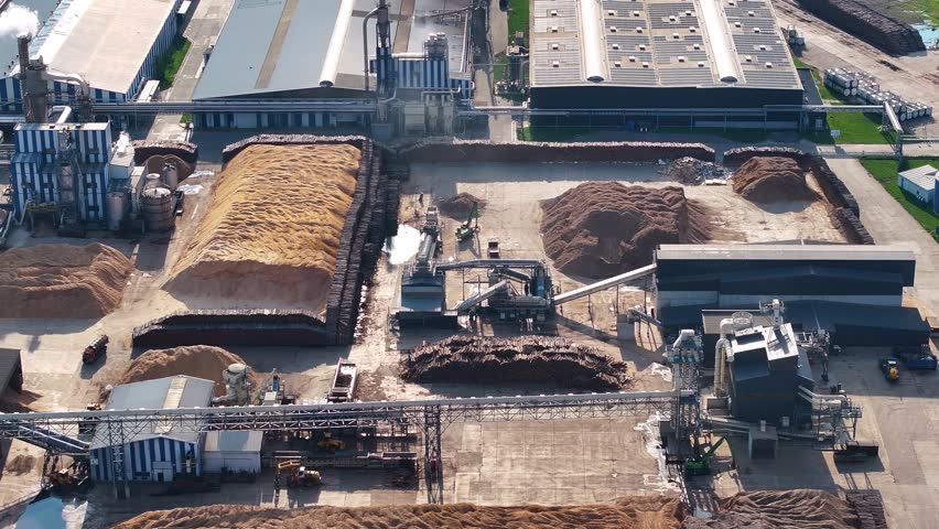 Exploring the modern wood processing plant from above with industrial activity