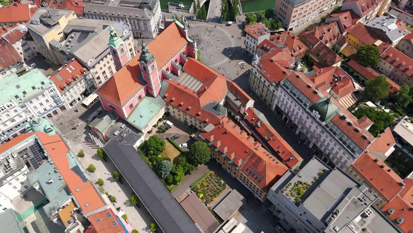 Aerial of Preseren Square and iconic Triple Bridge in Ljubljana’s old town, establishing high angle pan