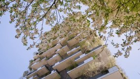 Vertical Forest Building EcoFriendly Cityscape Spring Blossoms Nature Architecture Design Sustainable Urban Balcony Plants Greenery Tower - Powered by Shutterstock - Get 15% off with code: PIKWIZARD15
