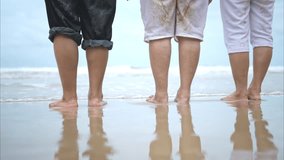 Foots of senior women enjoying a playful on the beach, happy as they splash through the waves - Powered by Shutterstock - Get 15% off with code: PIKWIZARD15