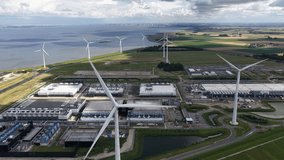 Wind turbines at a data center in Eemshaven, Groningen, The Netherlands. AI, cloud, server infrastructure, and renewable energy. Aerial view. - Powered by Shutterstock - Get 15% off with code: PIKWIZARD15