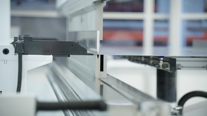 An automated bending machine bends a sheet of metal