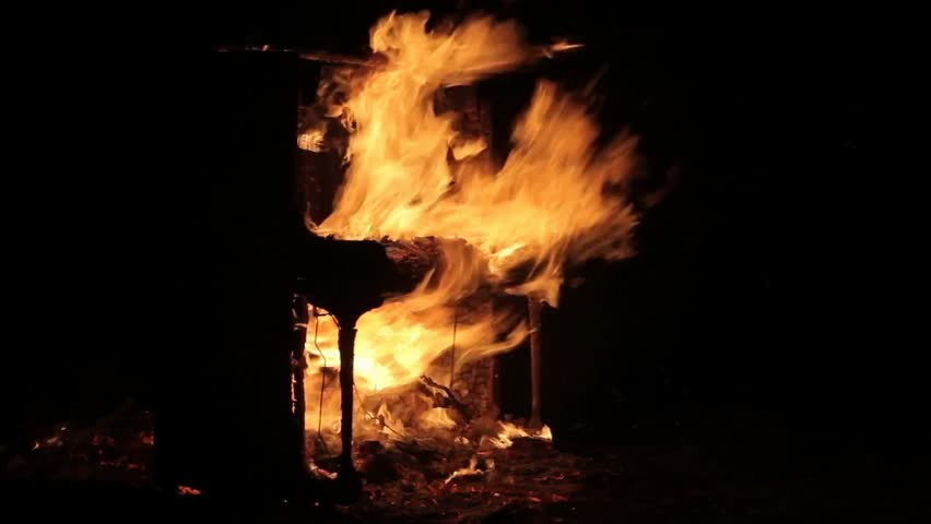 A piano engulfed in flames, symbolizing destruction, emotion, and dramatic contrast between music and fire. Conceptual footage with intense visual impact and metaphorical depth.
