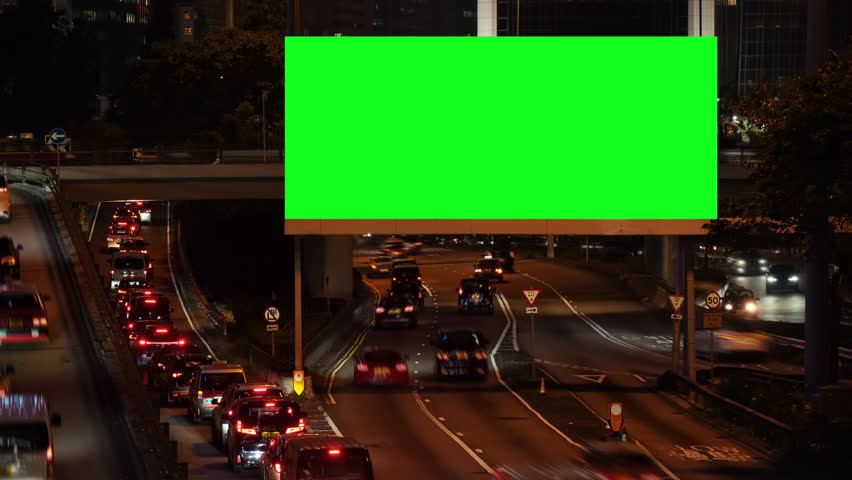 Night city street billboard stand with green screen. Green screen for text or copy.