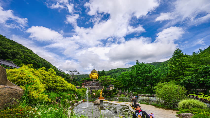 4K Timelapse Video of Buddha Statue in Maravijaya Posture,waujeongsa templeTemple in Summer and Beautiful Sky in South Korea, South Korea Landmarks, Korea Travel