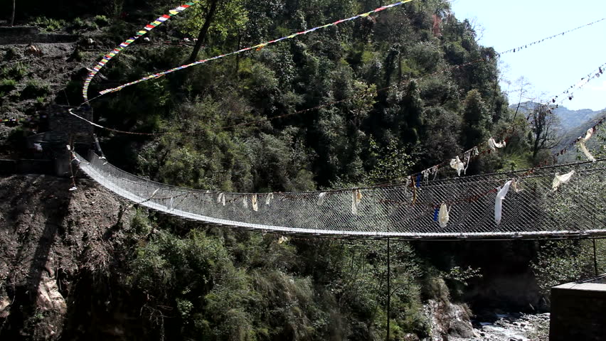 River Bridge In Rural Nepal Buddhist Prayer Flags. Gurkha built bridge in rural