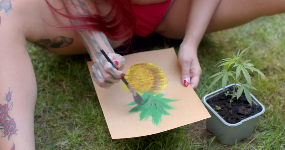 In this artistic video, a woman paints vibrant fruits and flowers in nature, beginning with a pineapple and later capturing a sunflowers details, celebrating arts beauty outdoors