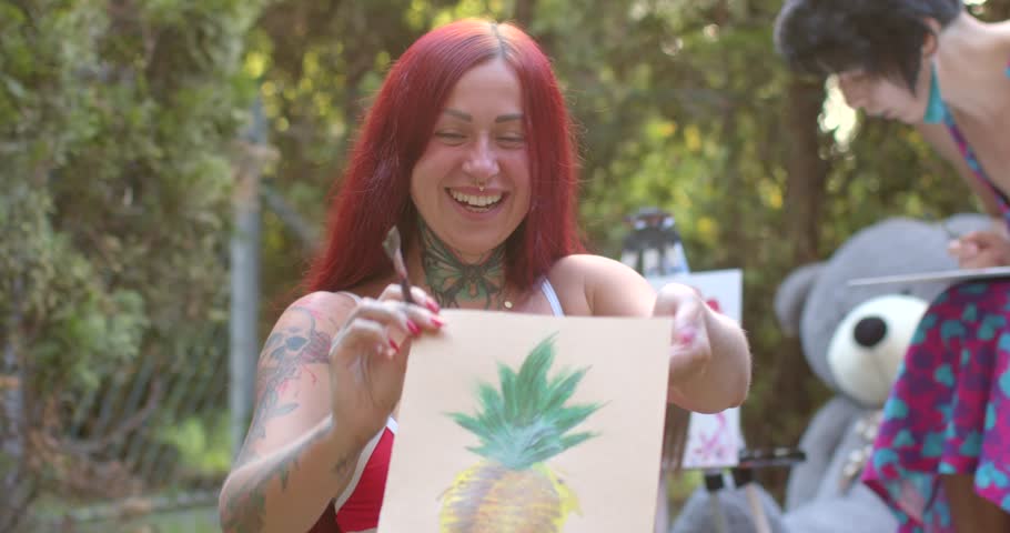 A womans creative journey unfolds as she enjoys a serene day on the grass, painting a vibrant pineapple and displaying her art