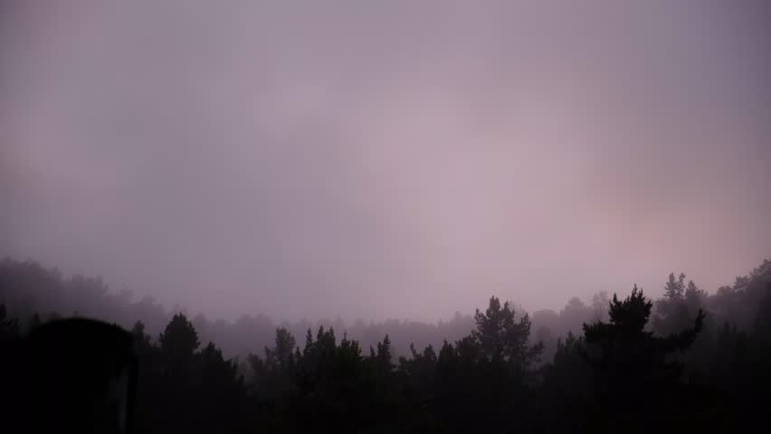 Misty landscape with fir forest. Cottage roof, bungalow. Surreal atmospheric mood. Dark Spruce Wood silhouette surrounded by Fog. Panoramic foothills, mountains. Surreal journey, spirituality