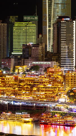 CHONGQING, CHINA - 18 MAY 2025 : Timelapse of the amazing Chongqing city skyline from a high vantage point at night in vertical